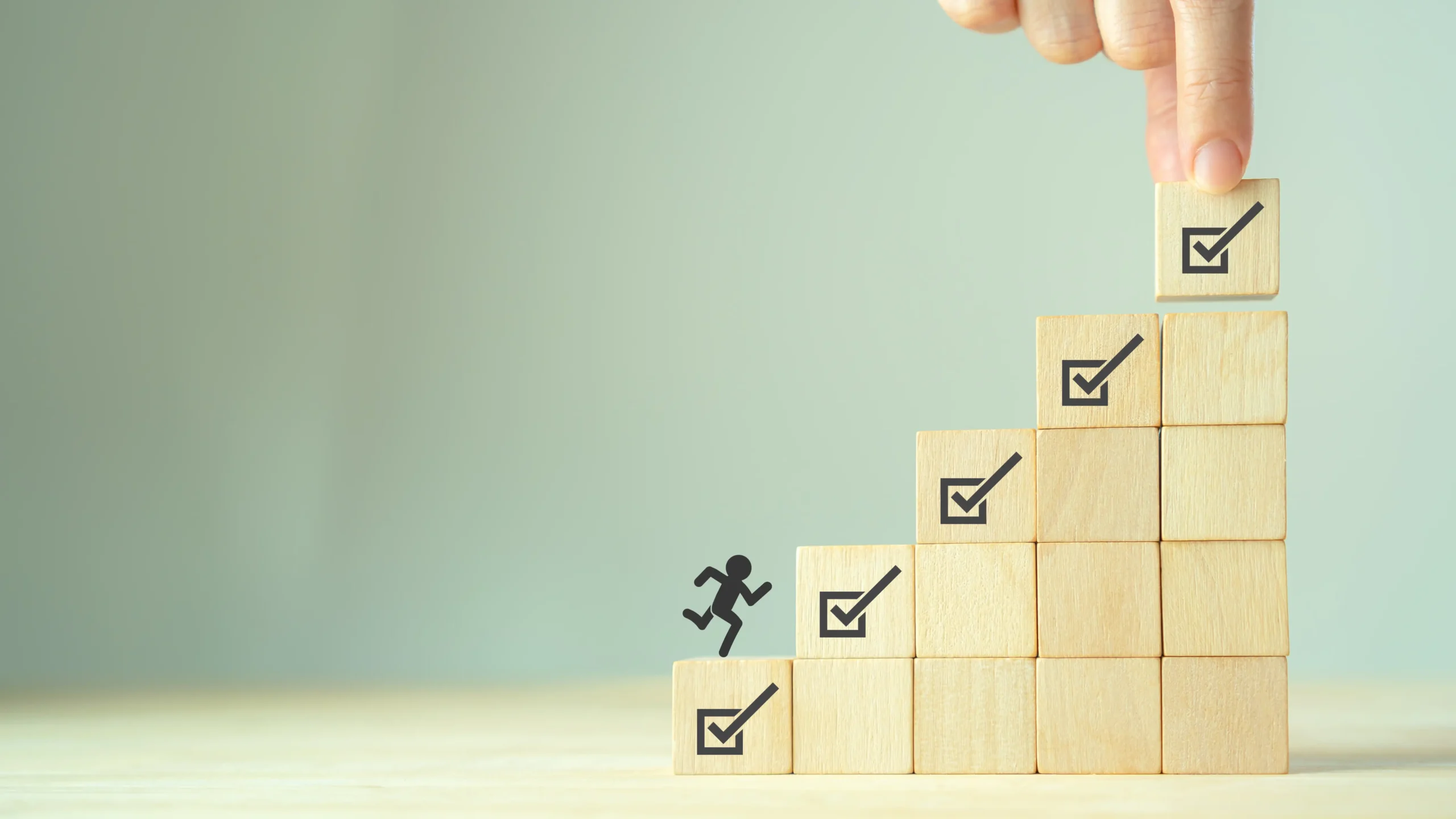 積み木を積む手と積み木の上を走る棒人間の画像